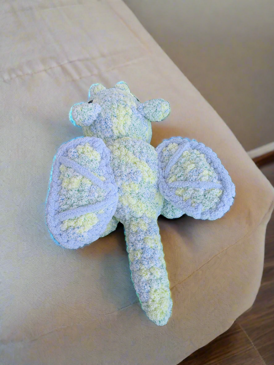 Crocheted dragon toy on a light-colored surface