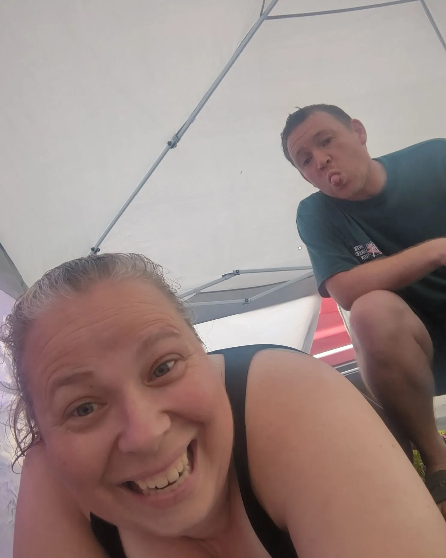 Ashley and Jacob sharing a playful moment at their market booth